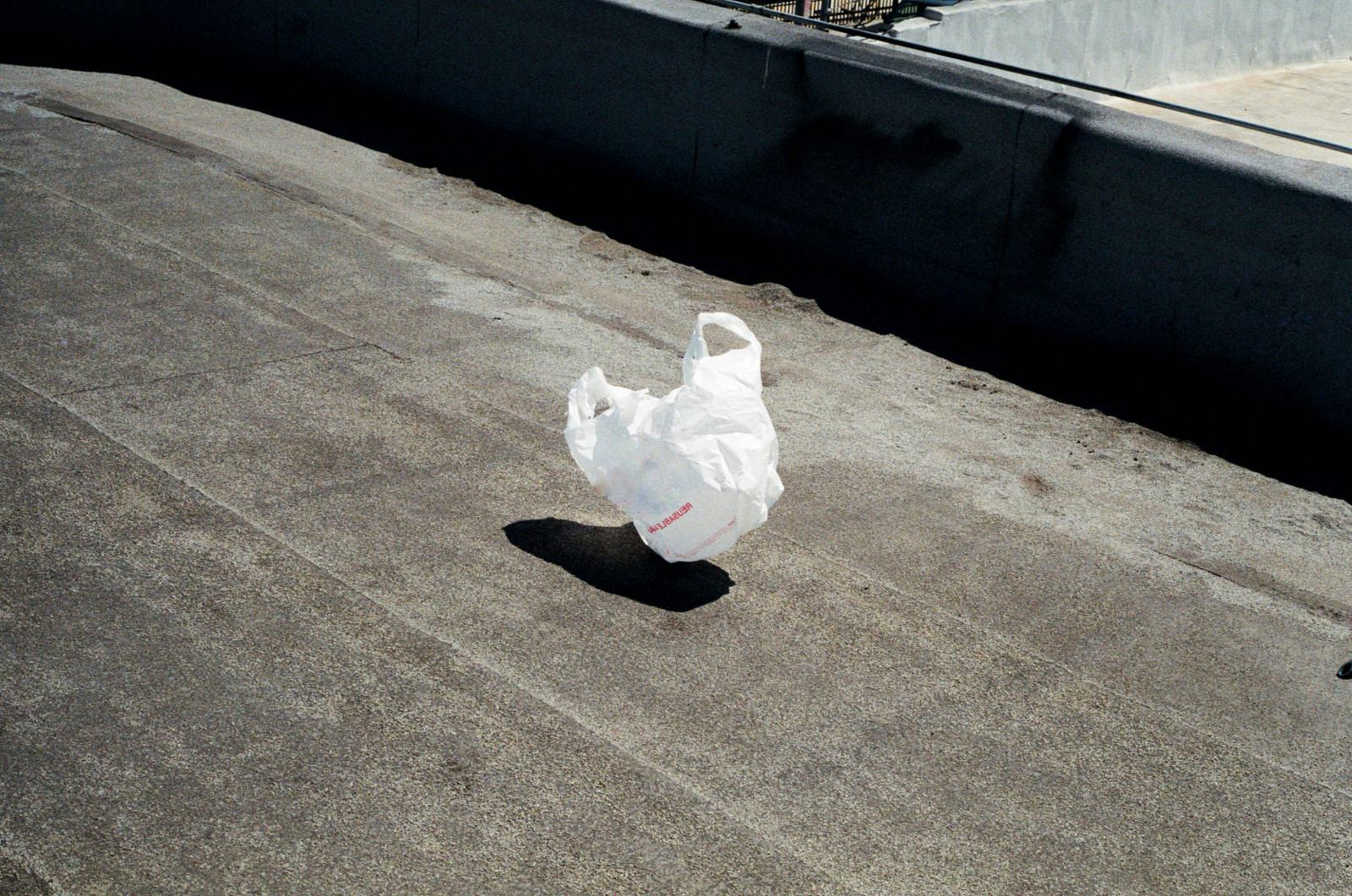 A white plastic bag on a concrete rooftop